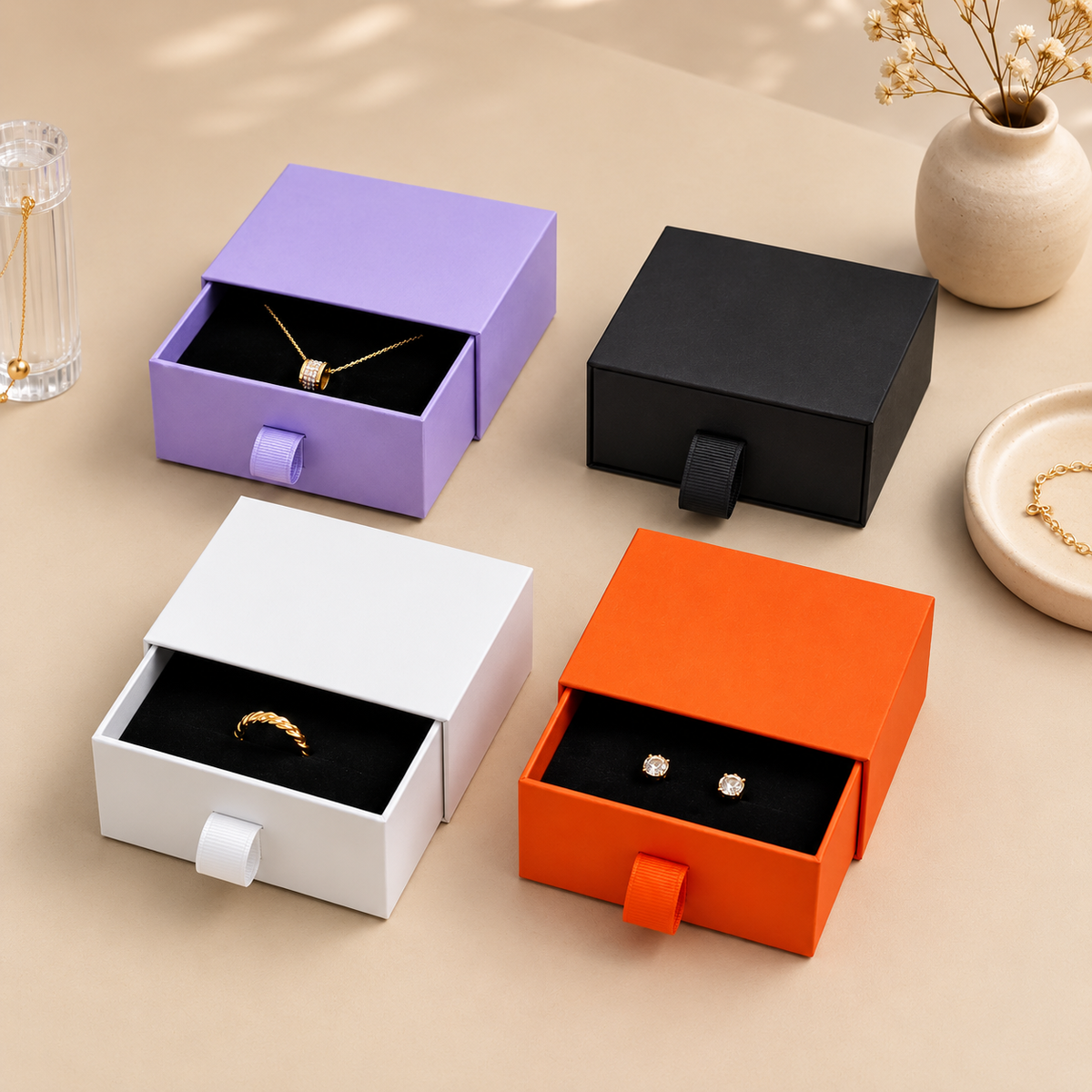 Pull-out jewelry drawers showing black insert layouts and ribbon tabs