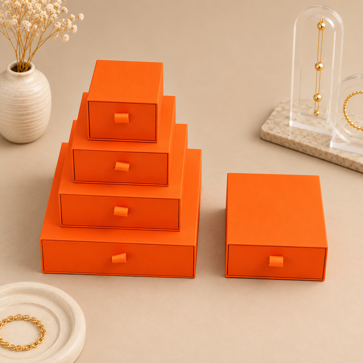 Orange paper drawer jewelry boxes shown in the five size options