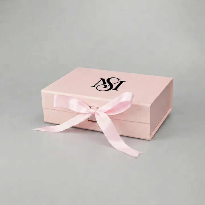 Black foil logo stamping example on a pink ribbon gift box