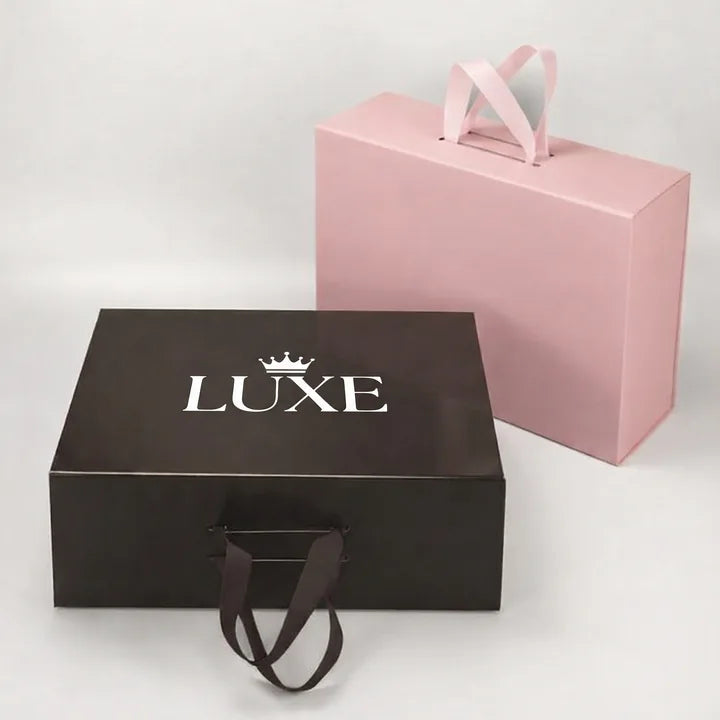 White foil logo stamping example on dark gift boxes